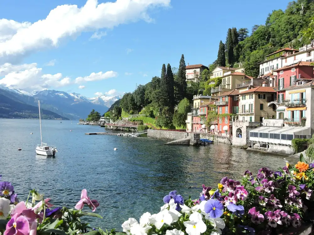 Colorful houses of Varenna on Lake Como with a sailboat